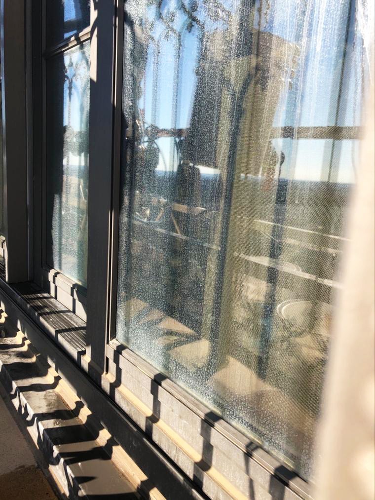 Hard water stains and streaks on windows of St. Regis hotel prior to Presto glass restoration