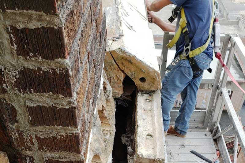 using a swing stage to perform masonry repairs on the Threefoot Building